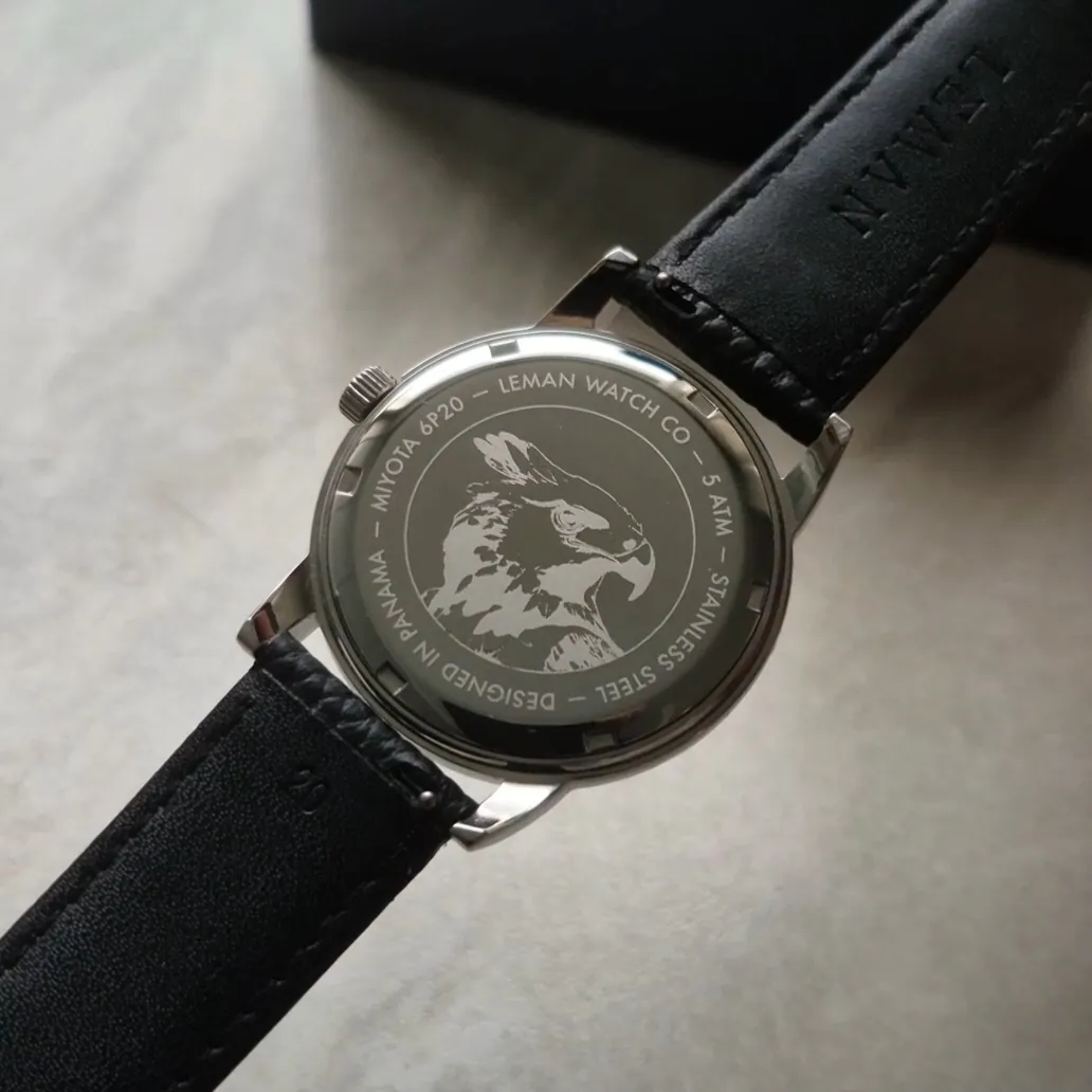 Leman Panama moonsphase watch featuring a black leather strap showcasing the caseback featuring a Harpy Eagle engraving