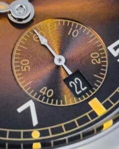 Baltany Dirty Dozen vintage watch micro-shot of the brown sunburst dial.
