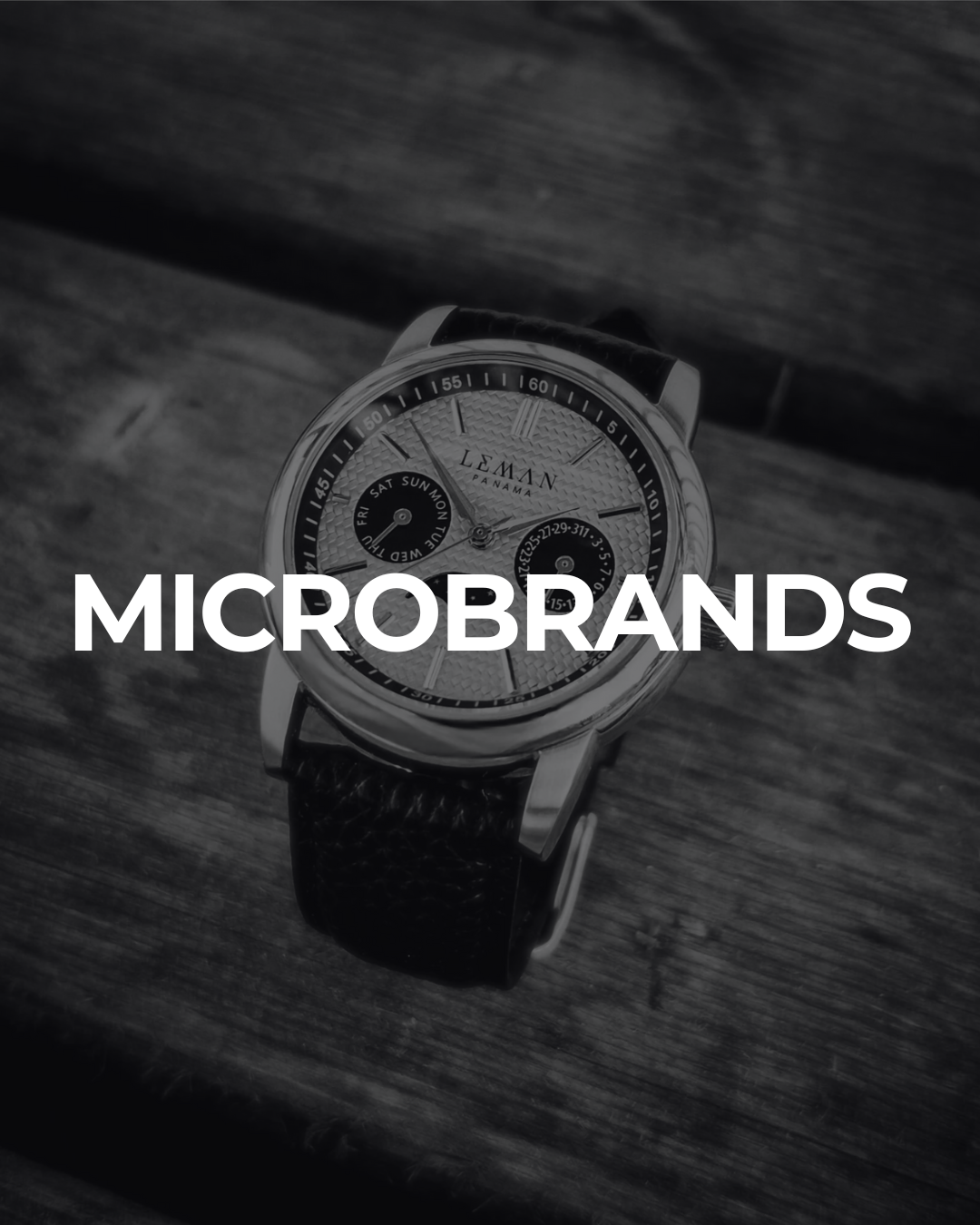 Microbrand wristwatch with leather strap on wooden surface, representing independent watchmakers